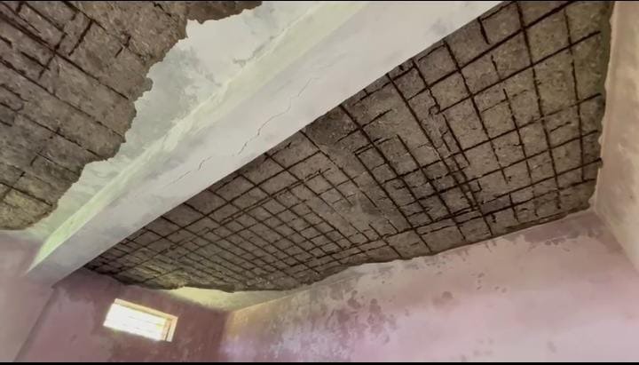Plaster fallen from the roof of a dilapidated school building in Rewa district